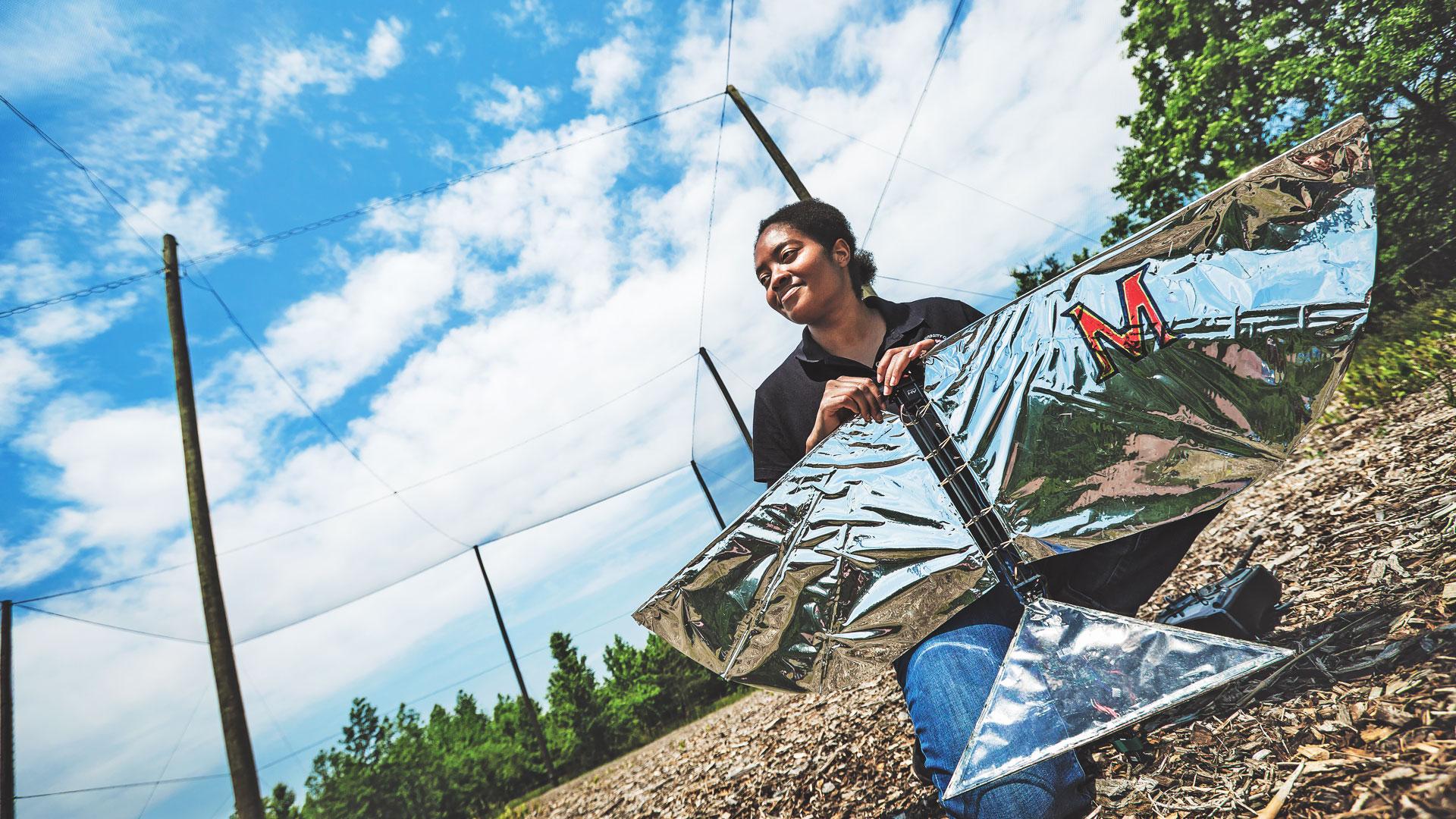 Lena Johnson (’14, M.S. ’16) with her Robo Raven, aerodynamic robotic bird,